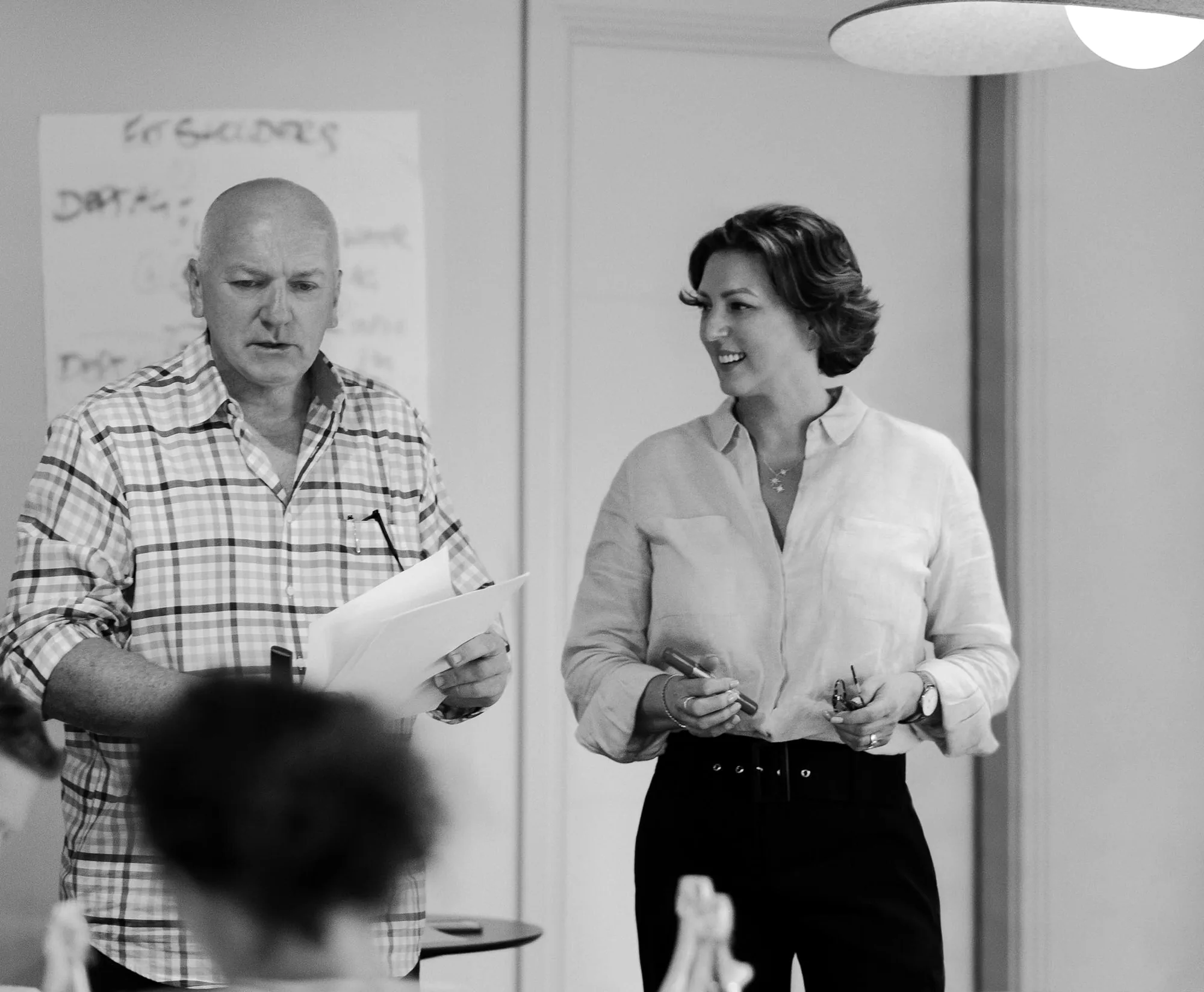 Rex Wood and Jacqui Ferris presenting a workshop in front of a flip chart